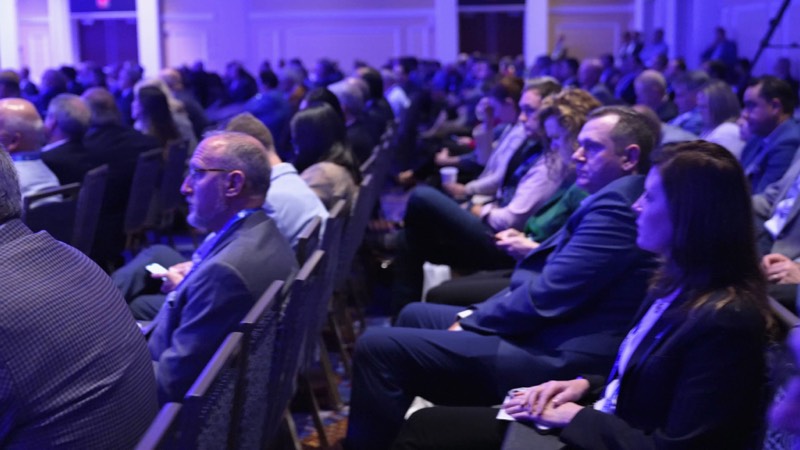 Conference attendees watching a session